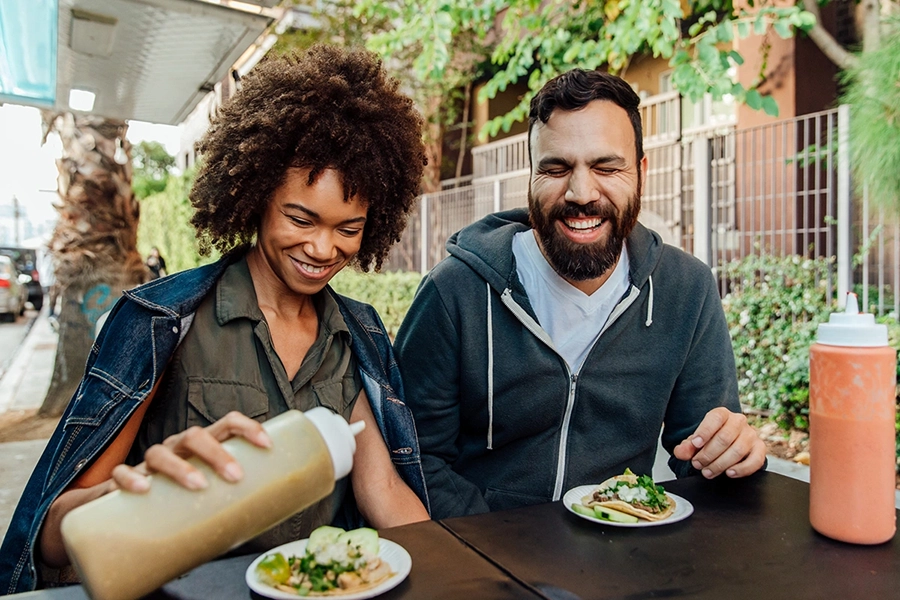 Couple sharing a laugh over lunch